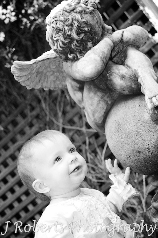 Baby girl with an angel statue - family portrait photography sydney